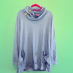 Blue cowl neck sweatshirt with front pockets.